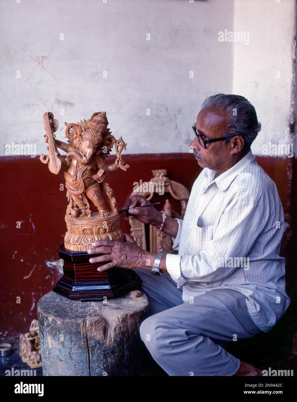 A craft man with his sandalwood Ganesha in Mysuru or Mysore, Karnataka, India, Asia Stock Photo