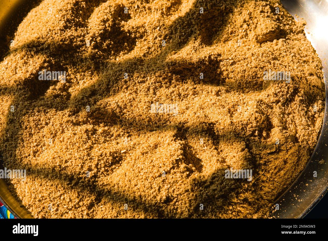 drying of grinded cumin seeds in the sun rays in india Stock Photo