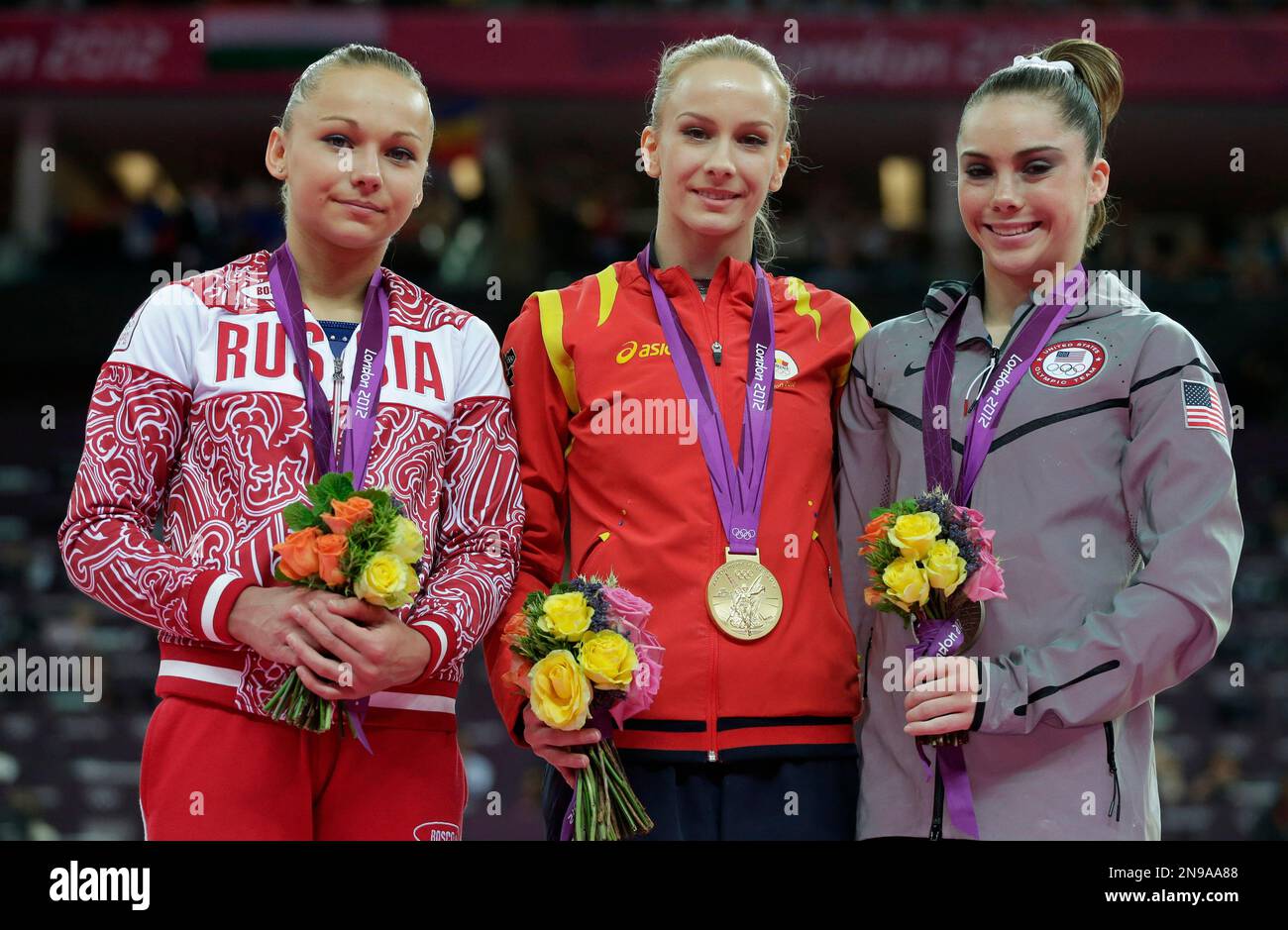 Russian gymnast Maria Paseka, left, Romania's gymnast Sandra Raluca ...