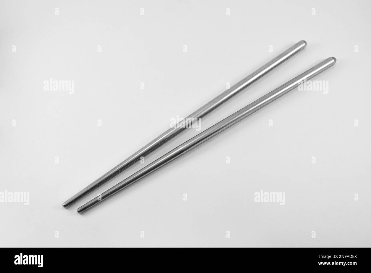Metal chopsticks isolated on white background. Stainless steel