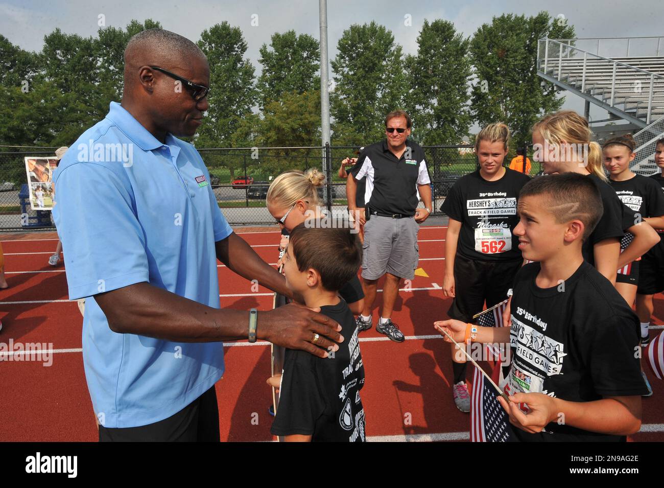 Olympic legend carl lewis interacts with competitors at the 35th