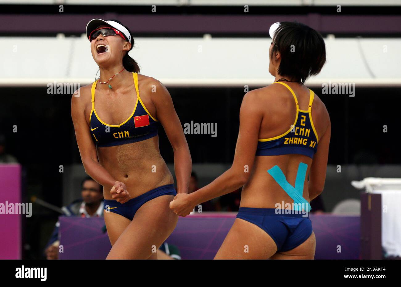 Chen Xue, left, of China celebrates with teammate Zhang Xi following a two  set win over Russia during a beach volleyball match at the 2012 Summer  Olympics, Saturday, Aug. 4, 2012, in
