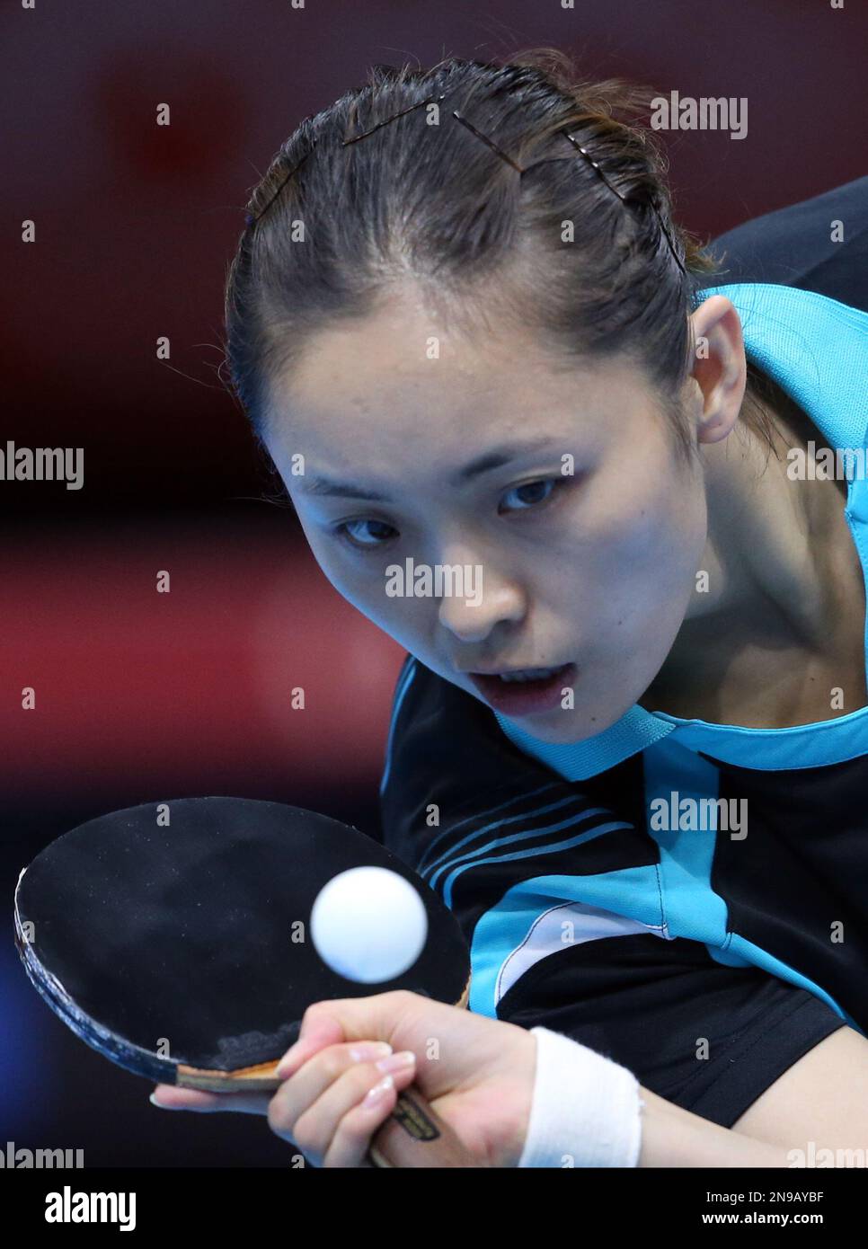 Poland's Qian Li returns a shot to Singapore's Tianwei Feng during the