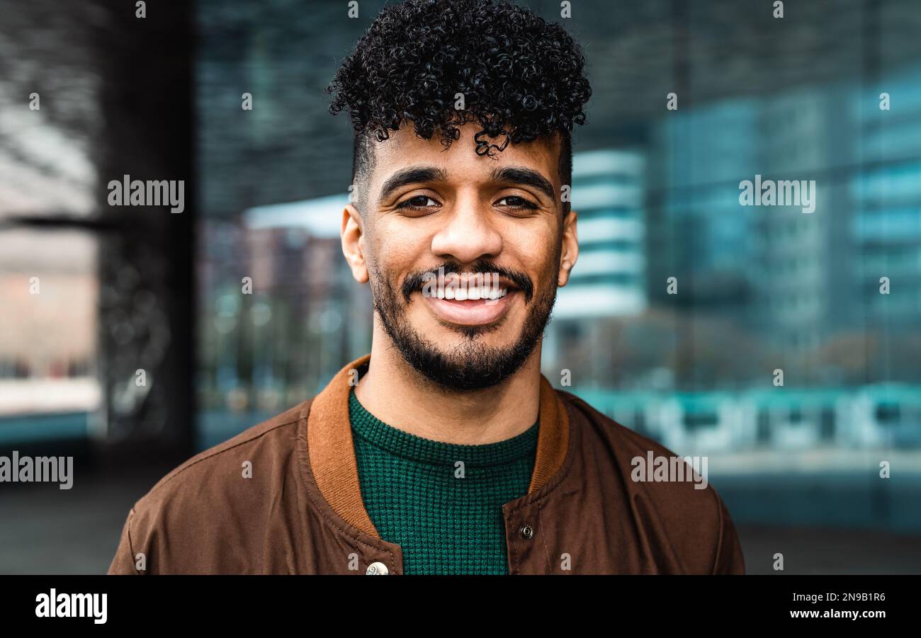 Happy young Latin man smiling in front of camera Stock Photo