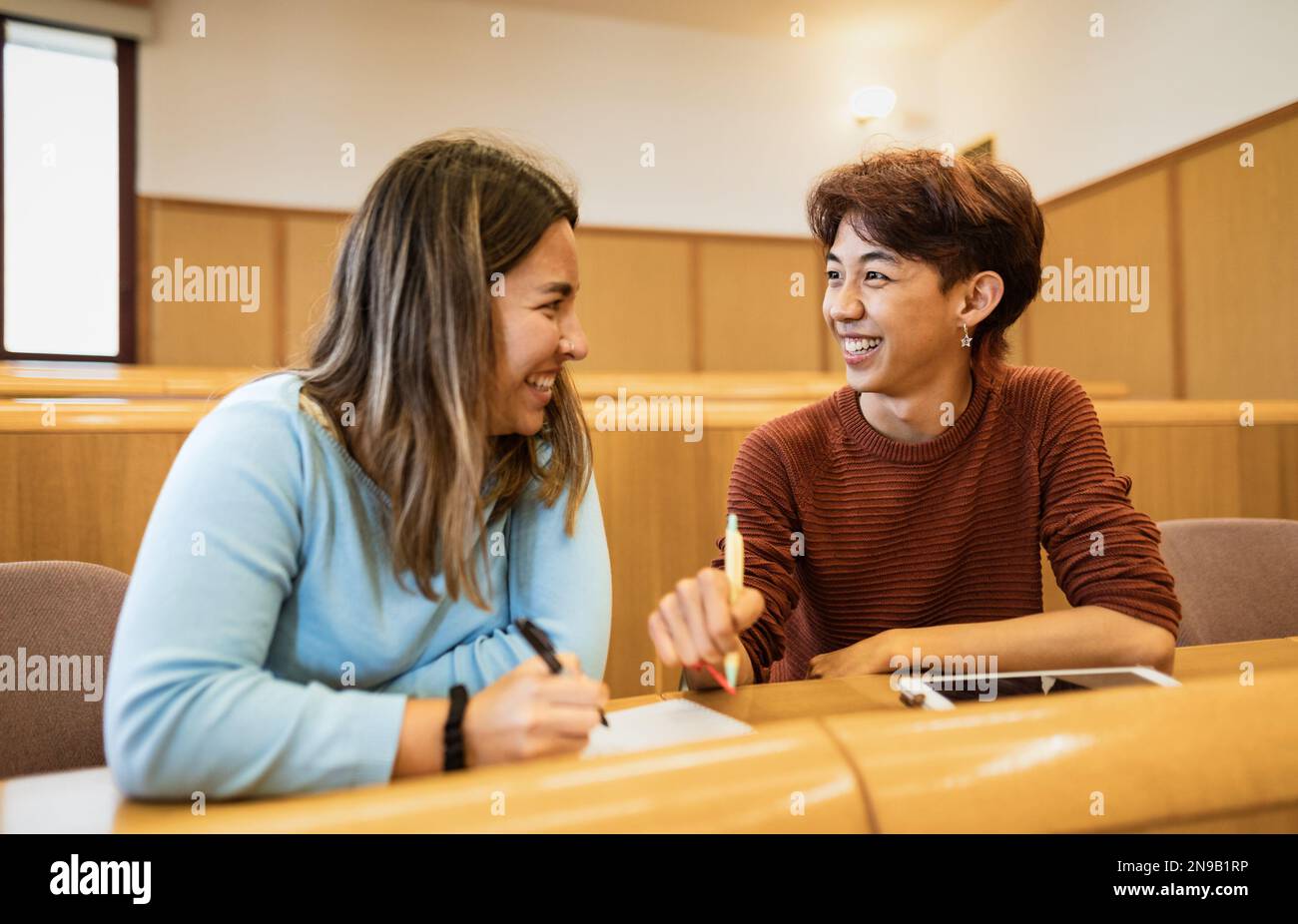 Young multiracial friends studying inside university classroom  - School education concept Stock Photo