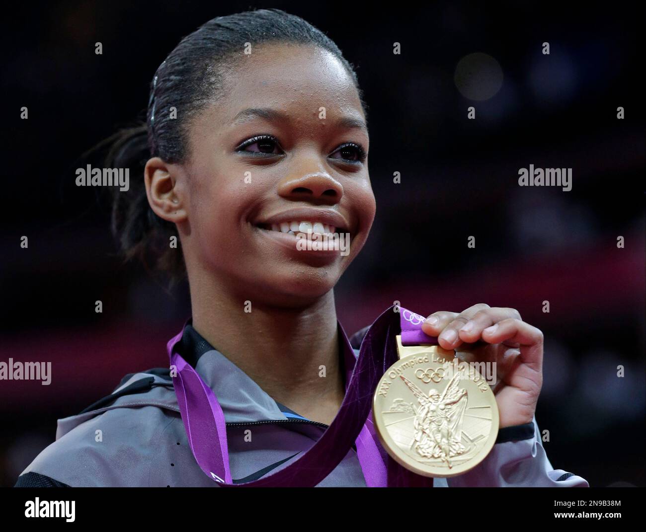 U.S. gymnast Gabrielle Douglas displays her gold medal during the