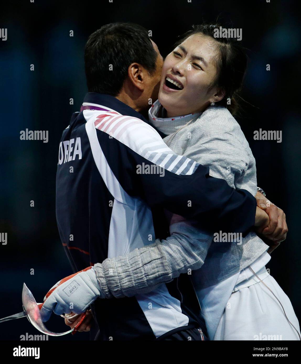 South Korea's Kim Jiyeon gets a hug from her coach after defeating