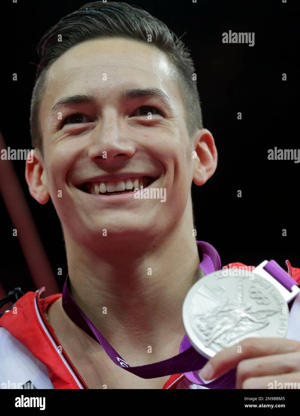German gymnast Marcel Nyugen displays his silver medal for the artistic