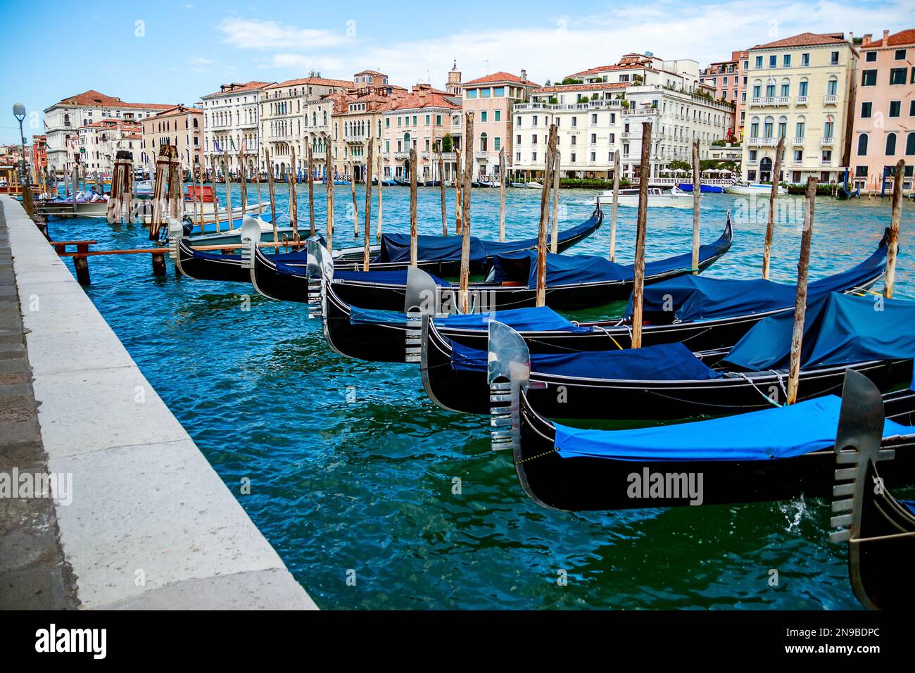 Row of blue gondolas moored at pier hi-res stock photography and images ...