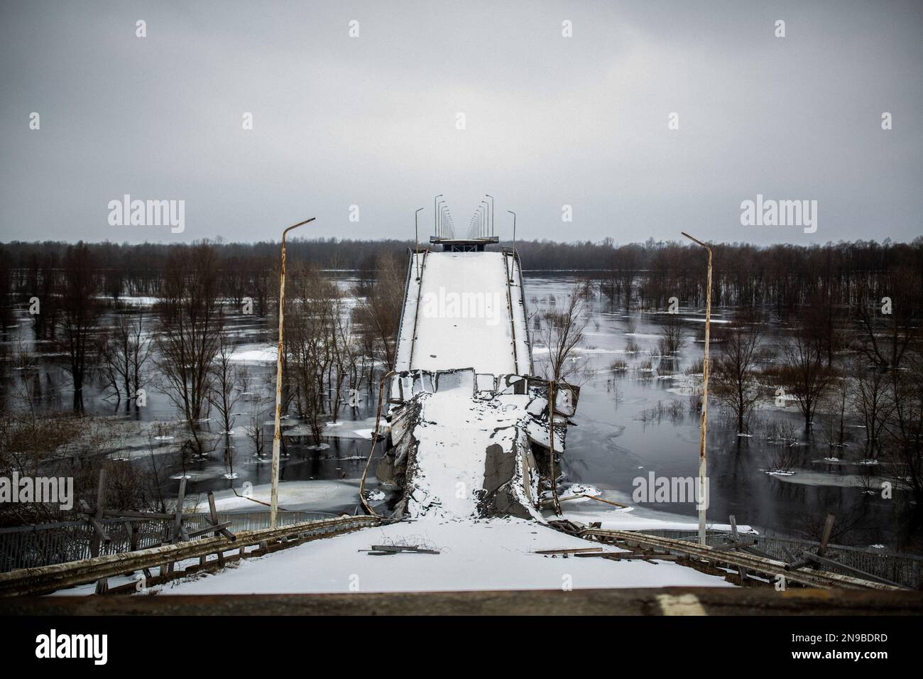 A destroyed bridge, covered by snow that crosses the completely frozen Dnepr river that separates the borders between Ukraine and Belarus, where civilians passed through before the Russian invasion to reach other areas more quickly, such as Chernobyl. (Photo by Marco Cordone/SOPA Images/Sipa USA) Credit: Sipa USA/Alamy Live News Stock Photo