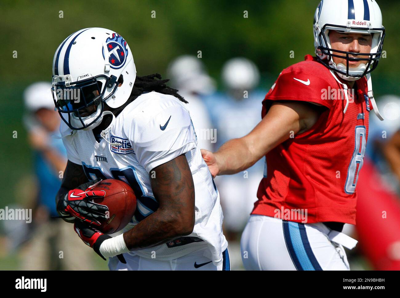 Tennessee Titans running back Chris Johnson (28) takes the hand-off from  quarterback Matt Hasselbeck (8) during NFL football camp at Titans'  headquarters Tuesday, July 31, 2012 Nashville, Tenn. (AP Photo/Wade Payne  Stock