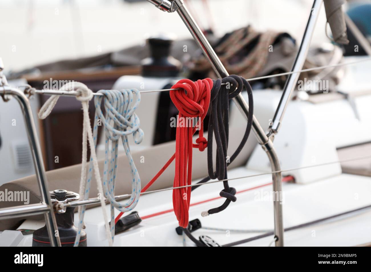 Nautical ropes on a deck. Winch and nautical ropes on a sailing boat. Details of sailing equipment on the boat. Close-up of rope knot, sailor's knot l Stock Photo