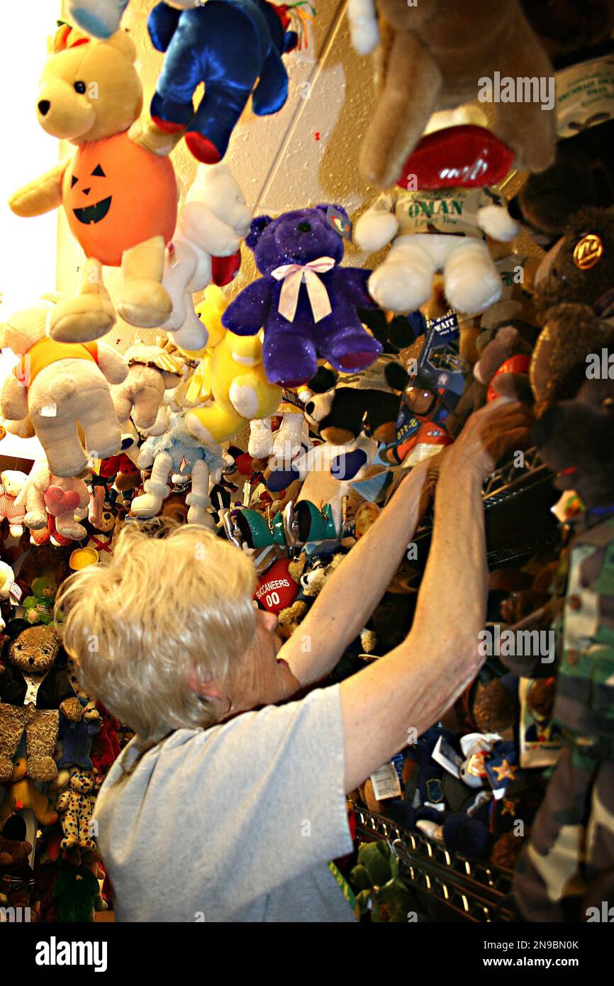 Jackie Miley 63 reaches for a teddy bear in this July 21 2012 photo at Teddy Bear Town in Hill City S.D. With 7 790 teddy bears in her collection Miley holds the
