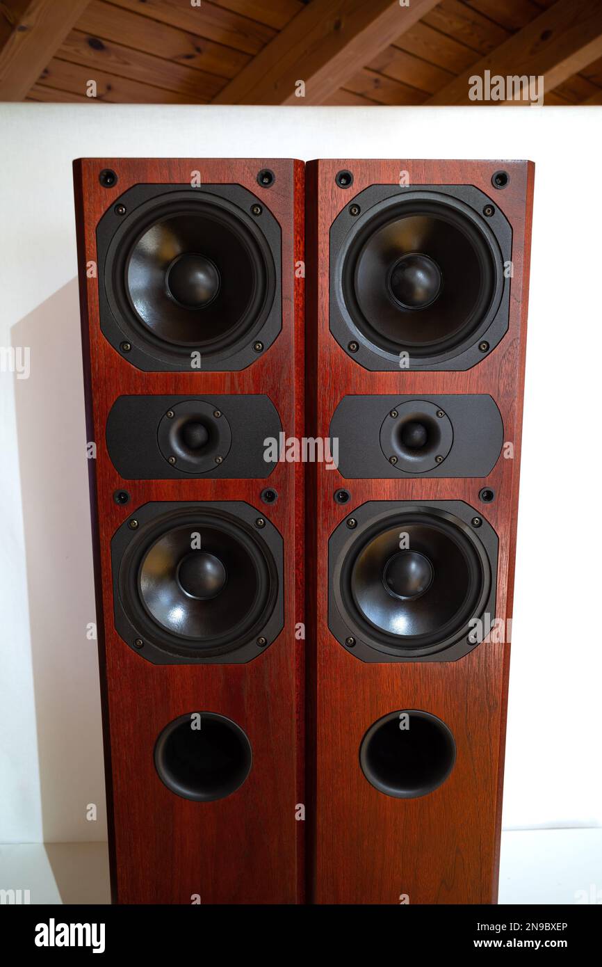 A pair of retro style vertical wooden tower speakers with multiple speakers. Stock Photo