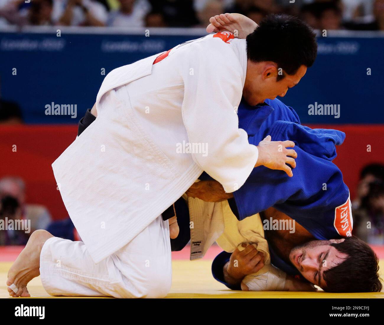 Wang Ki-Chun of South Korea, top, and Mansur Isaev of Russia, compete during the mens 73-kg judo competition at the 2012 Summer Olympics, Monday, July 30, 2012, in London