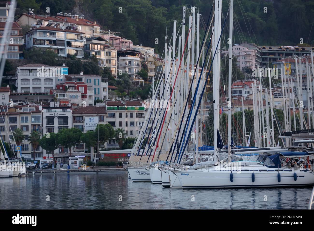 Fethiye, Turkey, November 9, 2022: Yachts and sailboats stand in the marina against the backdrop of residential buildings in the city Stock Photo