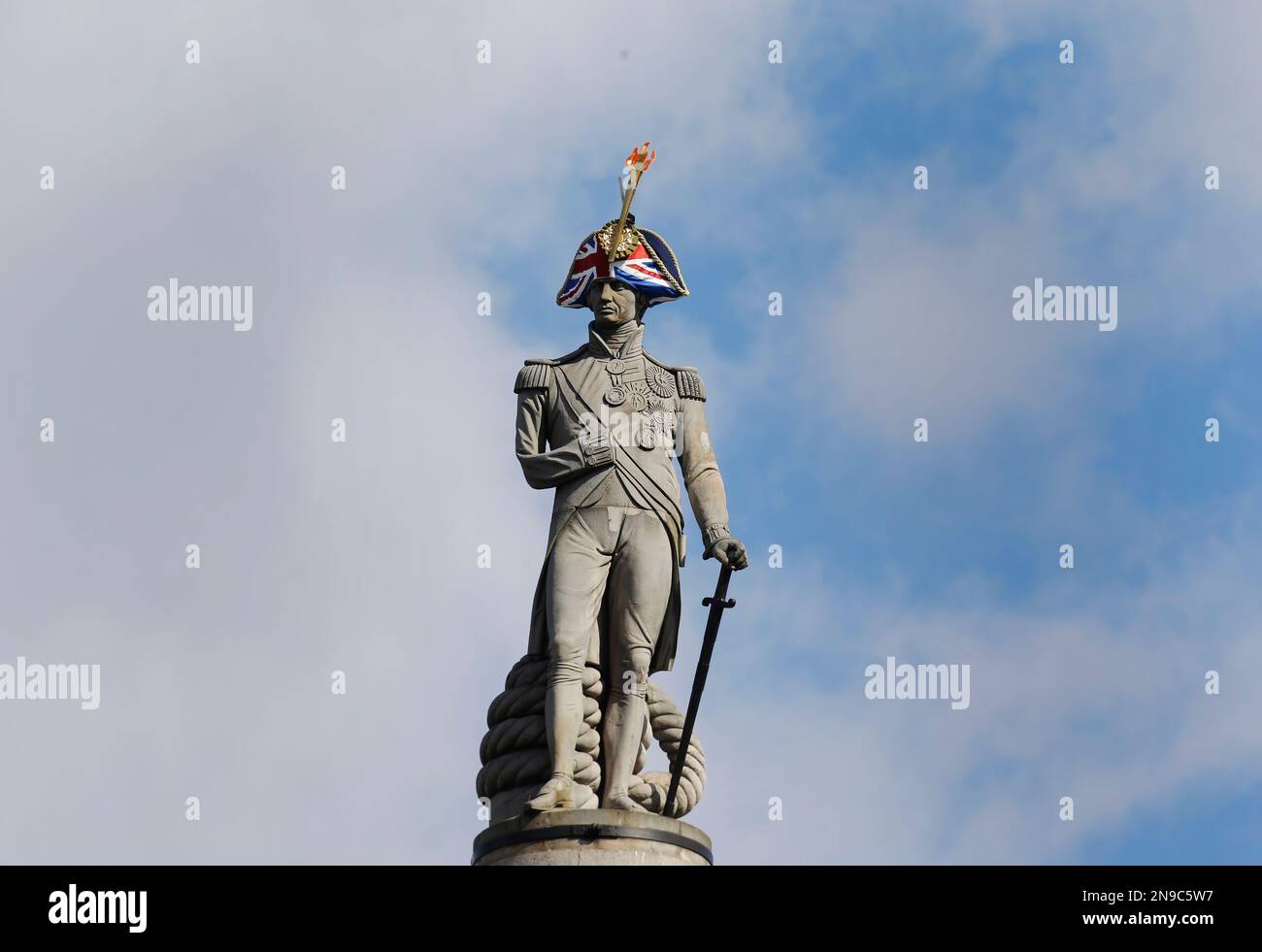 The statue of Admiral Lord Nelson is decorated with a hat and an ...