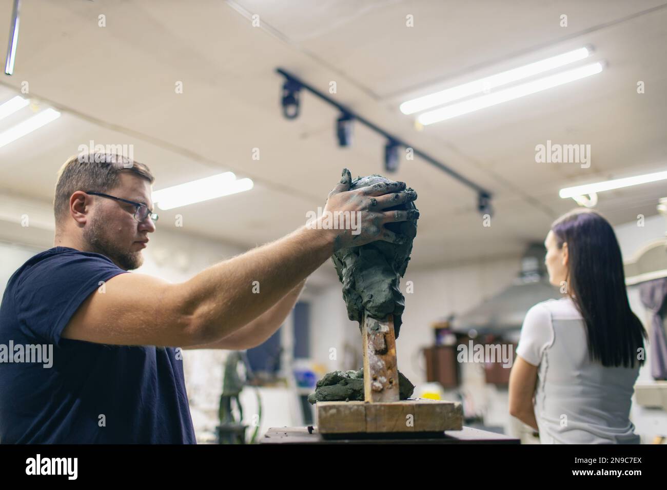 Man sculptor creates sculpt bust clay human woman model sculpture