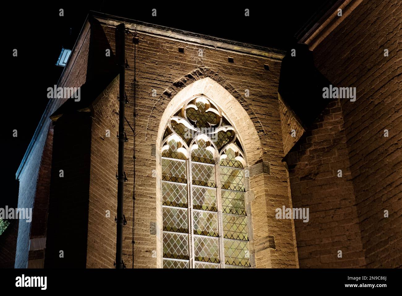 A close-up shot of a gothic-styled window on a stone wall Stock Photo ...