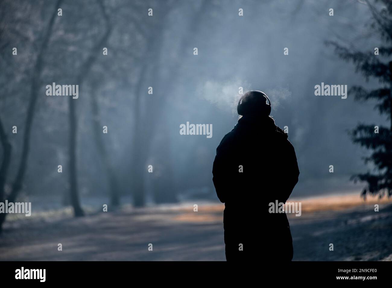 Walking alone in winter listening to music Stock Photo