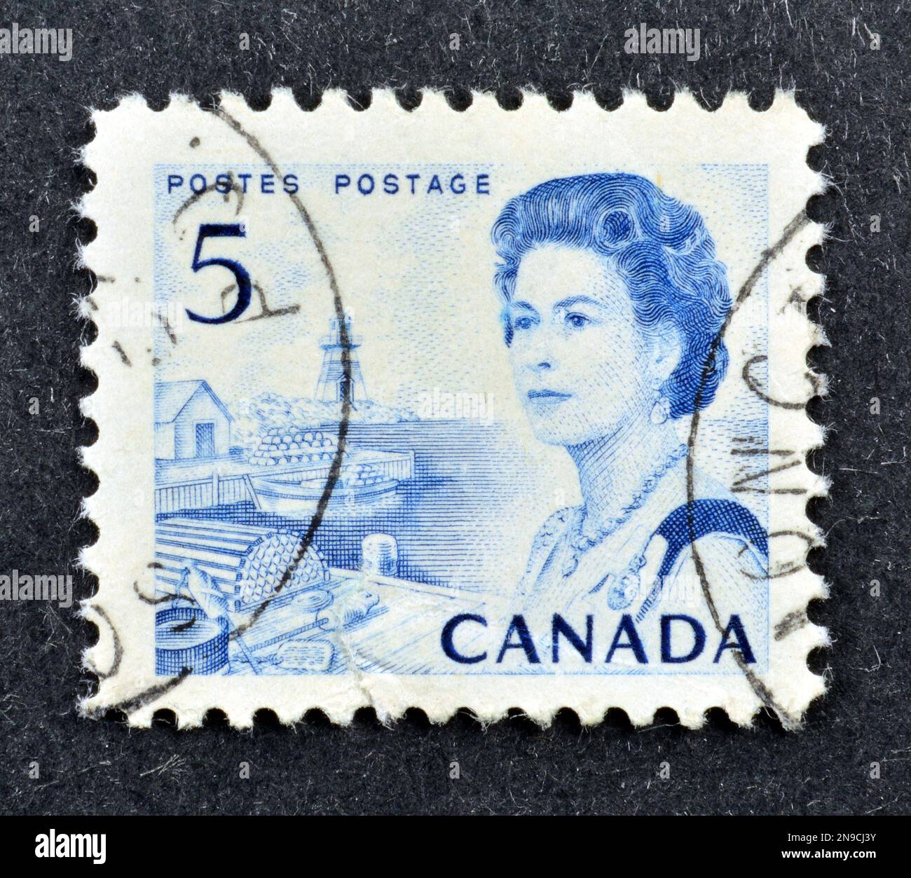 Cancelled postage stamp printed by Canada, that shows fishing port on