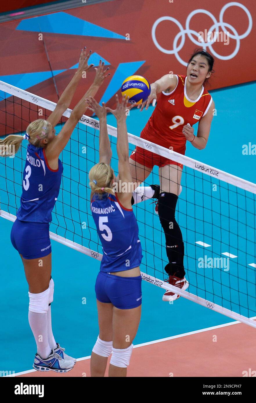 China's Yang Junjing (9) spikes the ball over Serbia's Ivana Djerisilo ...