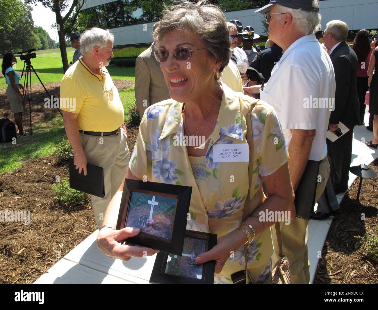 Lois Rao shows friends a picture of her son's grave and the police dog ...