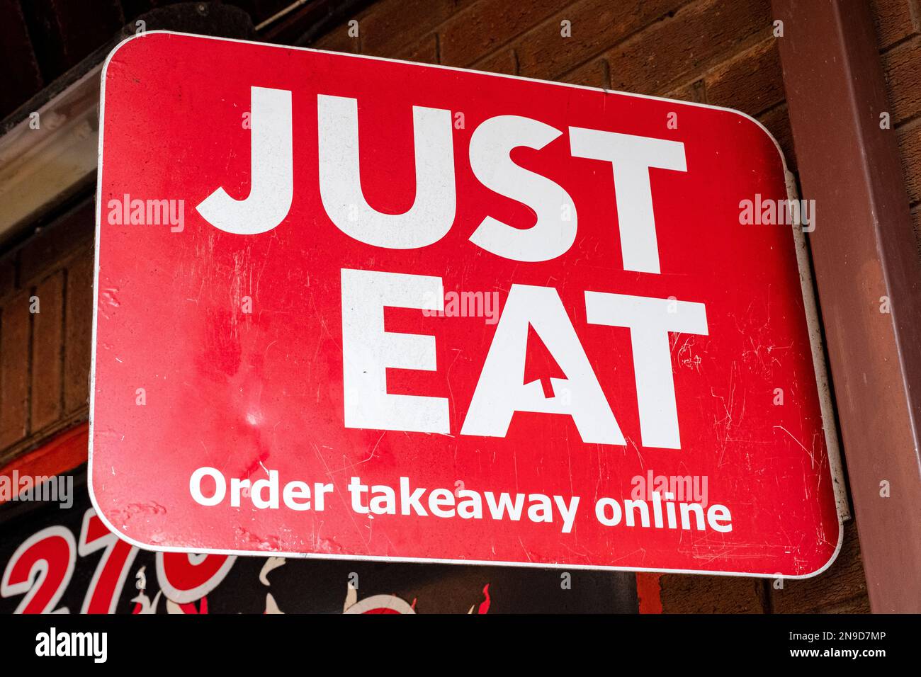 Just Eat, order takeaway online sign on outside wall UK Stock Photo