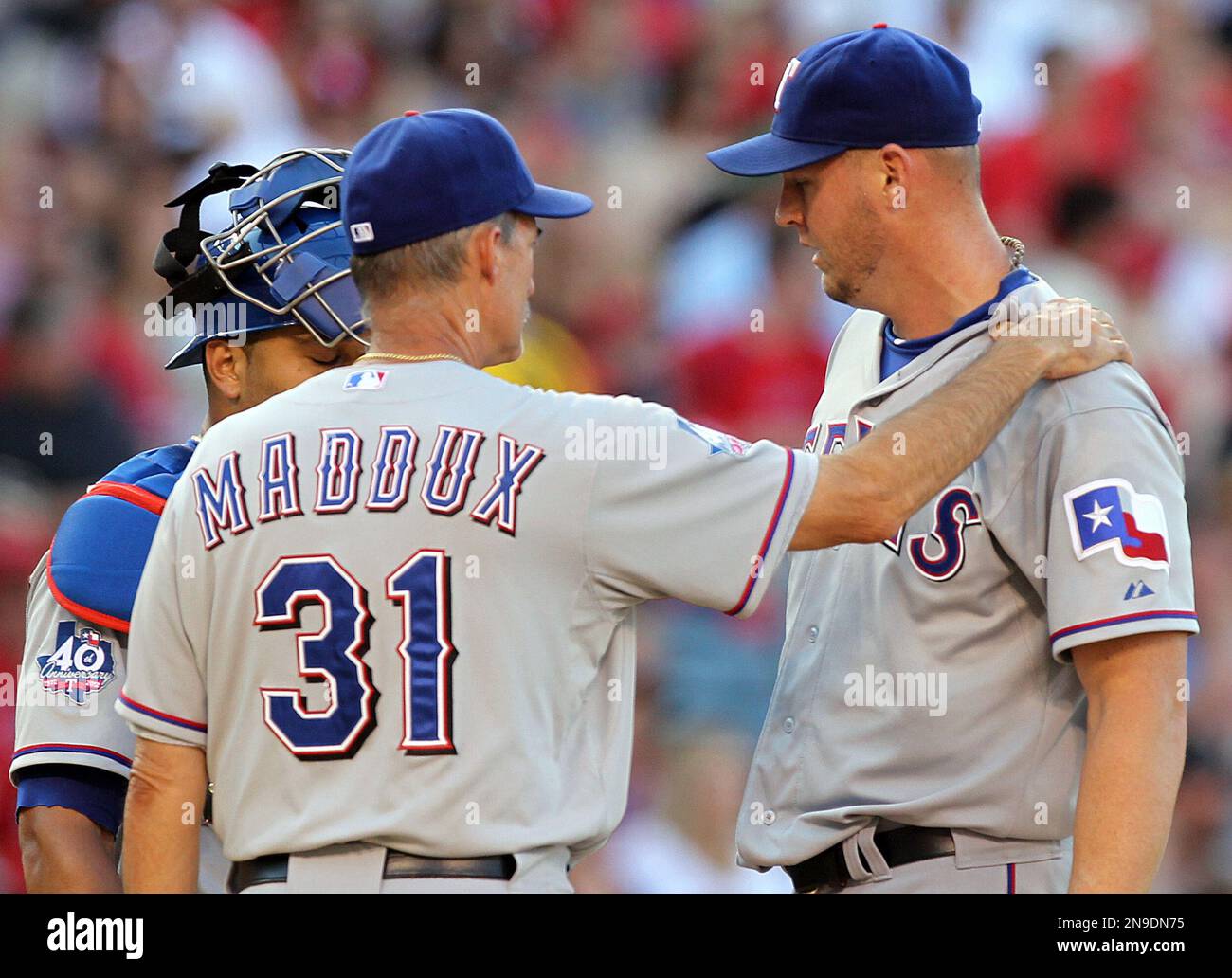 Texas Rangers pitching coach Mike Maddux steadies starting pitcher Matt