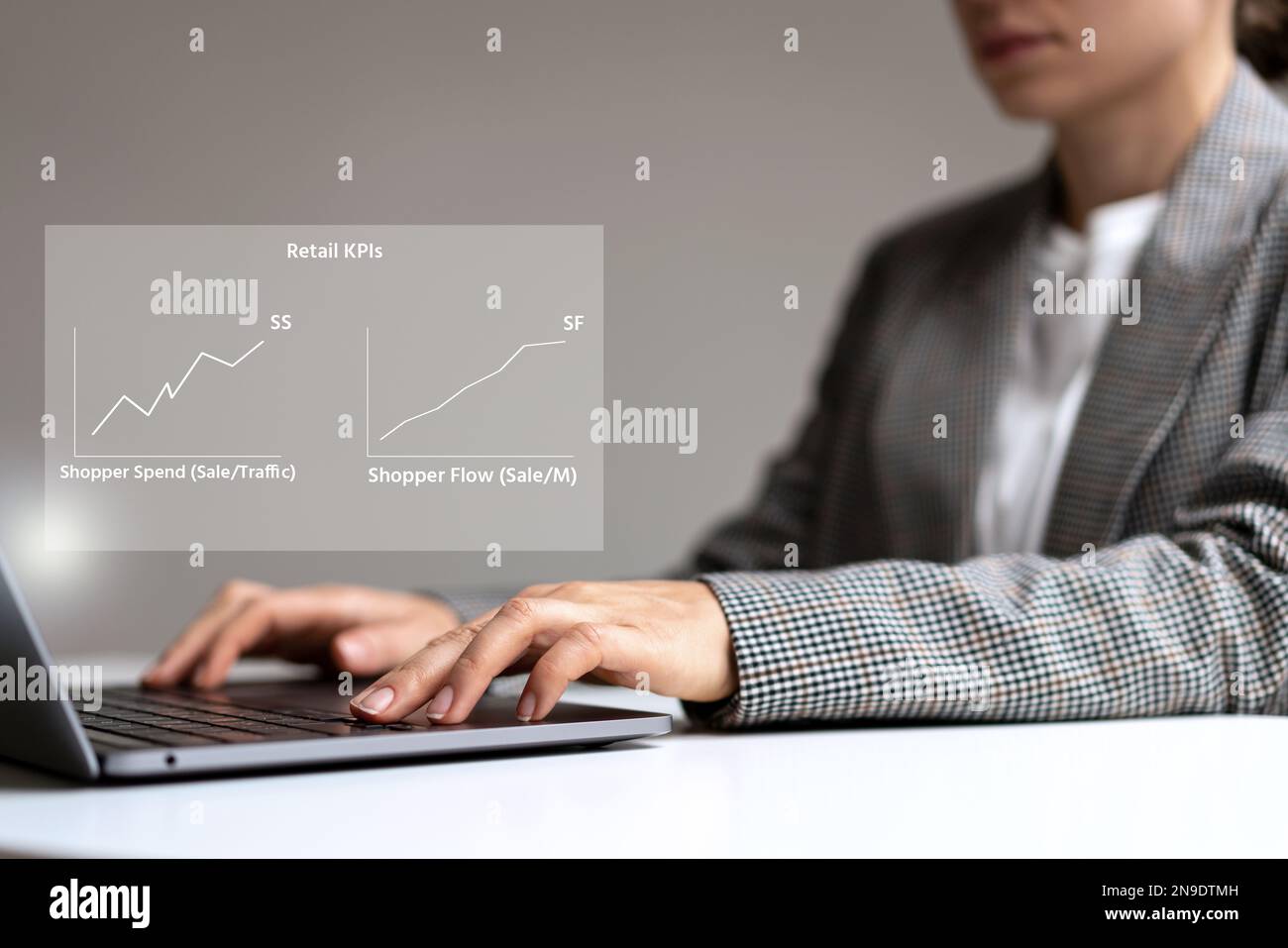 Businesswoman using laptop analyzing business kpi Shopper Spend and Shopper Flow retail rates. Stock Photo