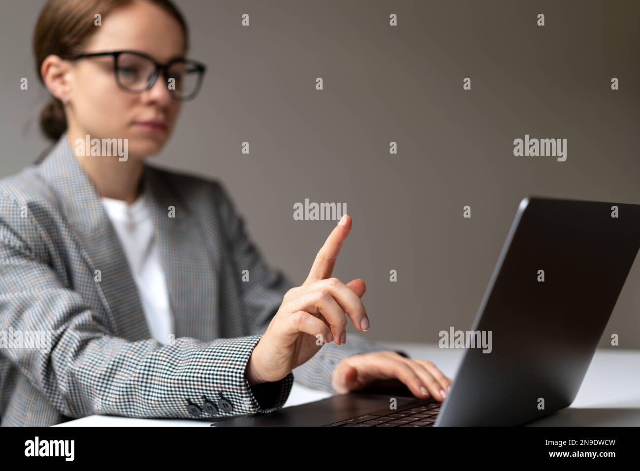 Defocused woman in background touching with her finger virtual display mockup template. Stock Photo