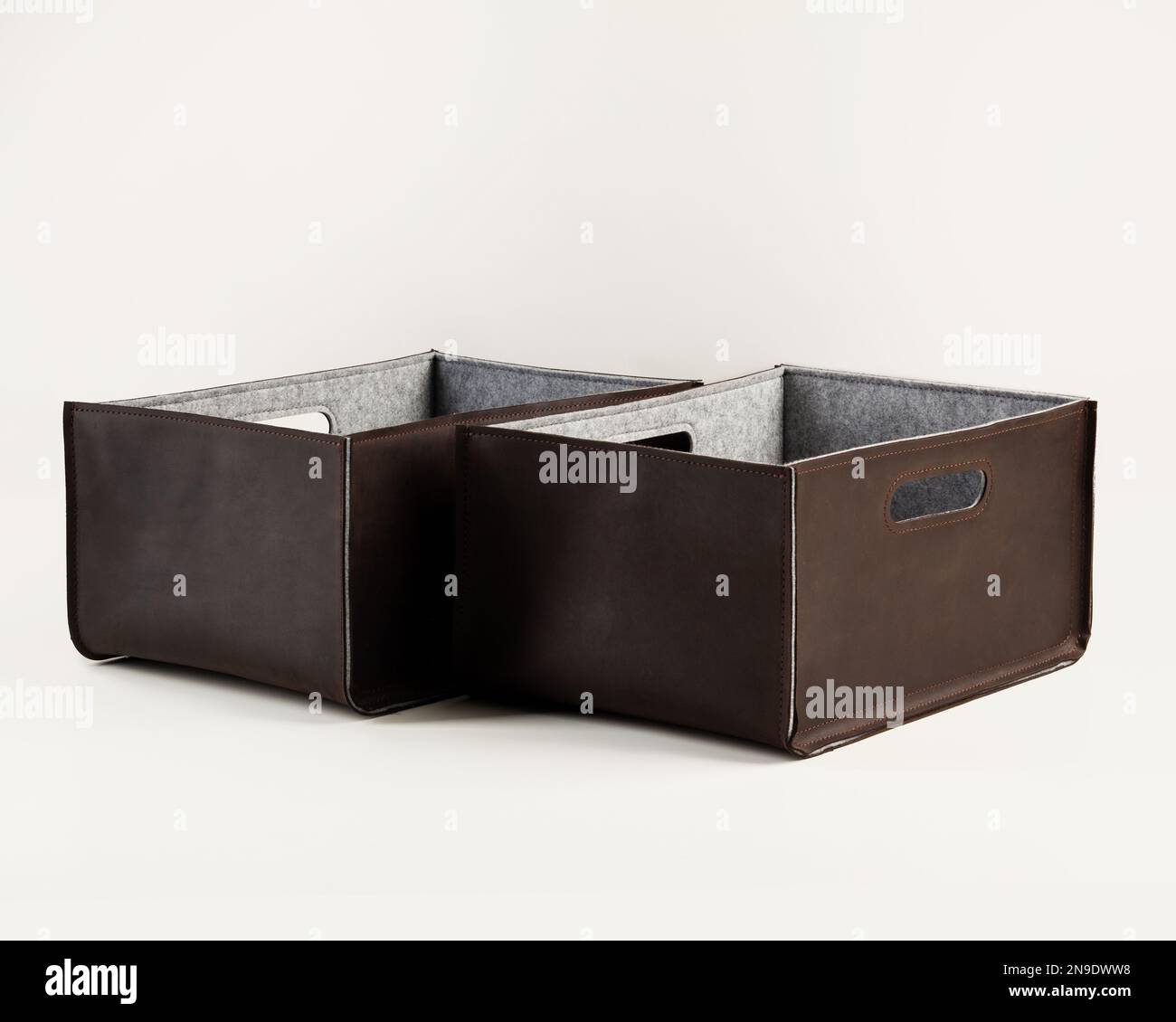 Two handcrafted brown faux leather storage boxes Stock Photo