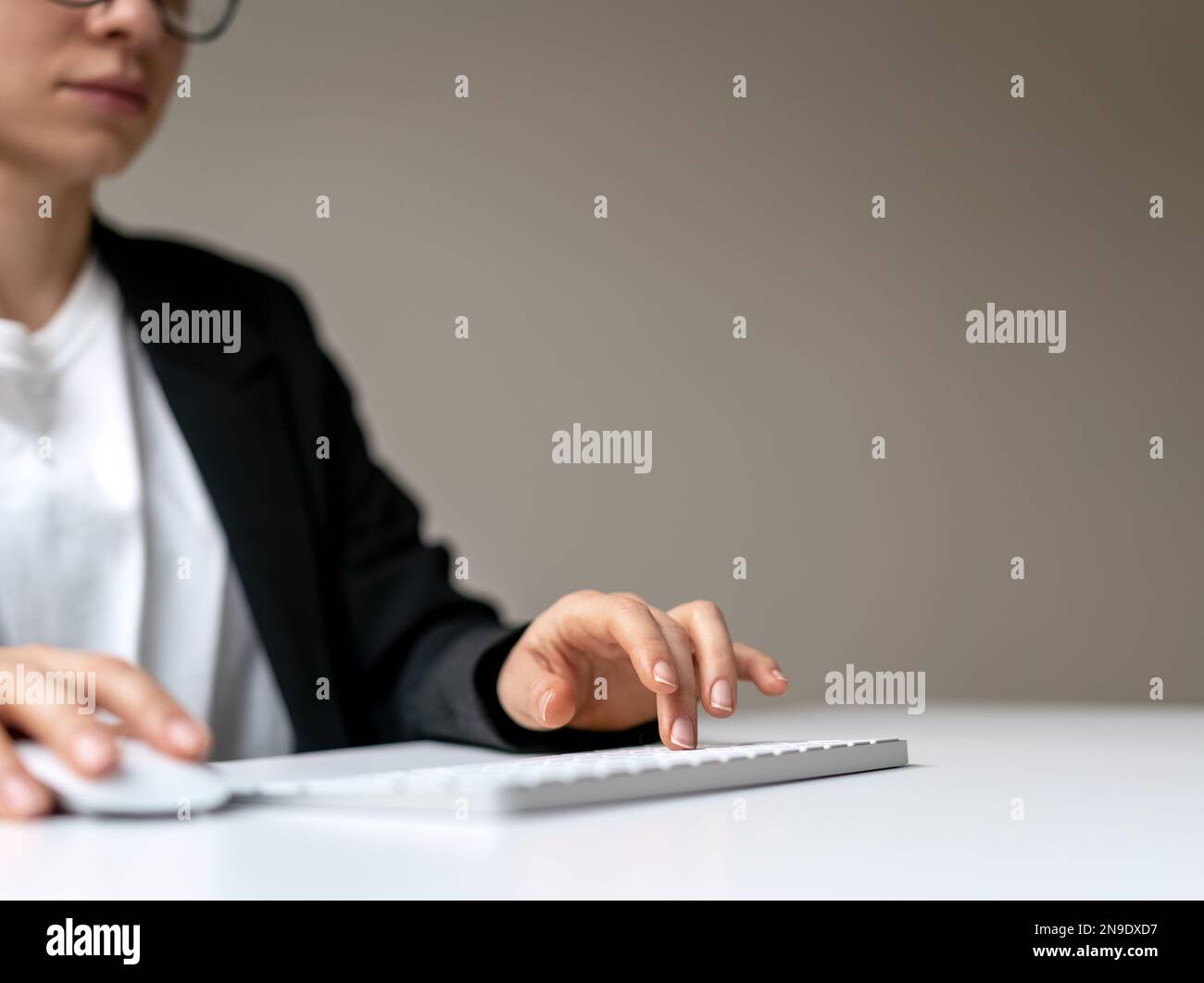 Female business person press keyboard button and using computer mouse. Stock Photo