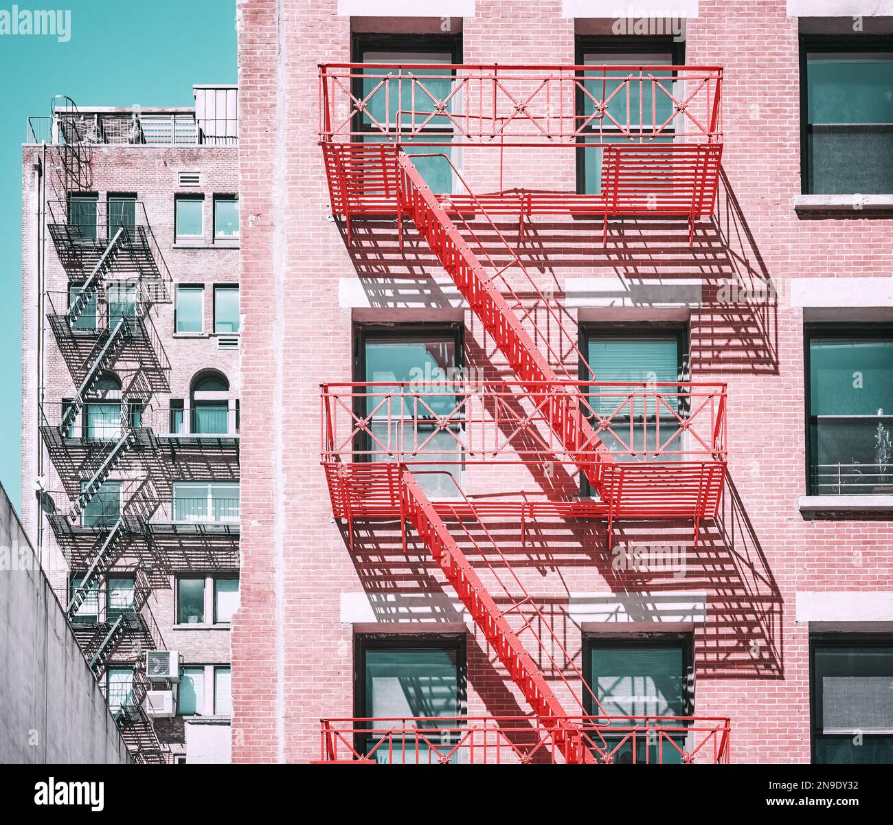 Old buildings with fire escapes in New York City, color toning applied ...
