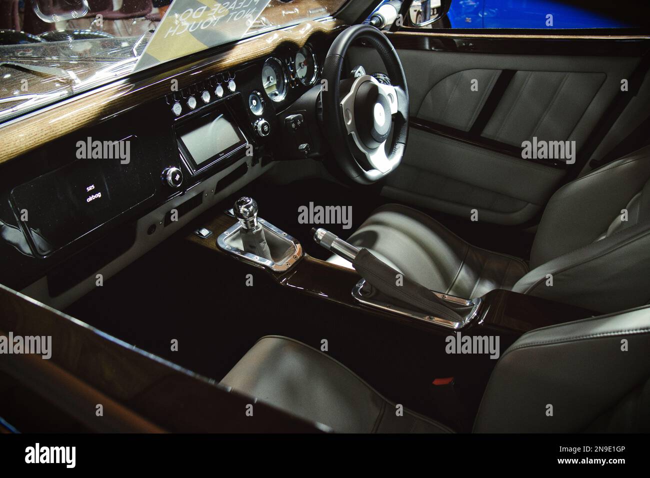 A close-up shot of the inside and the steering wheel of the Morgan Aero 8 sports car Stock Photo