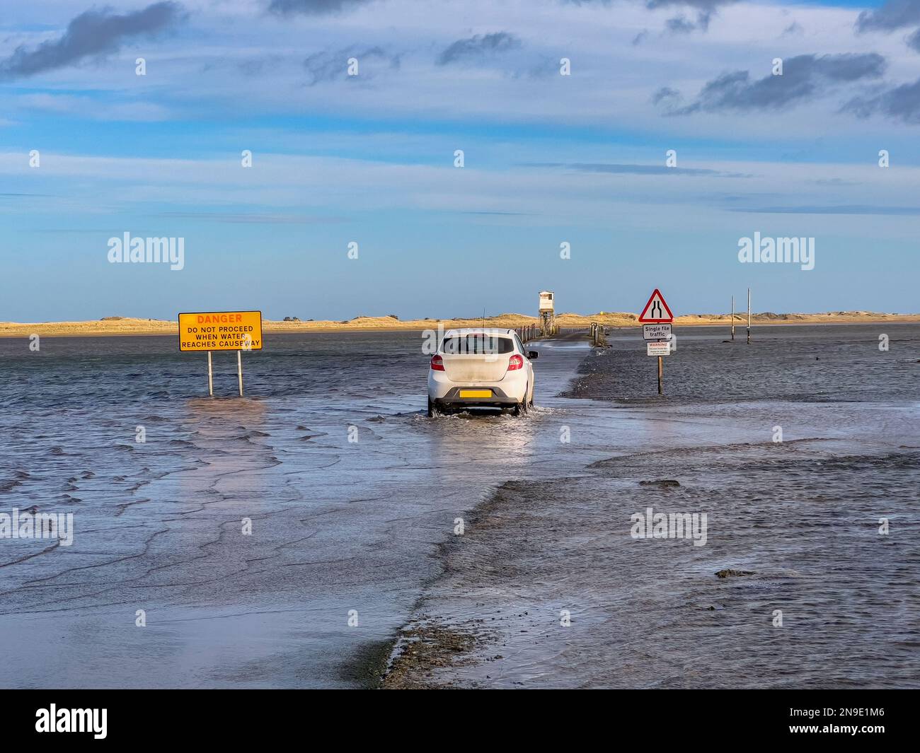 The causeway to Lindisfarne on Holy Island off the coast of Northumberland in northeast England. Only passable at low tide. Stock Photo