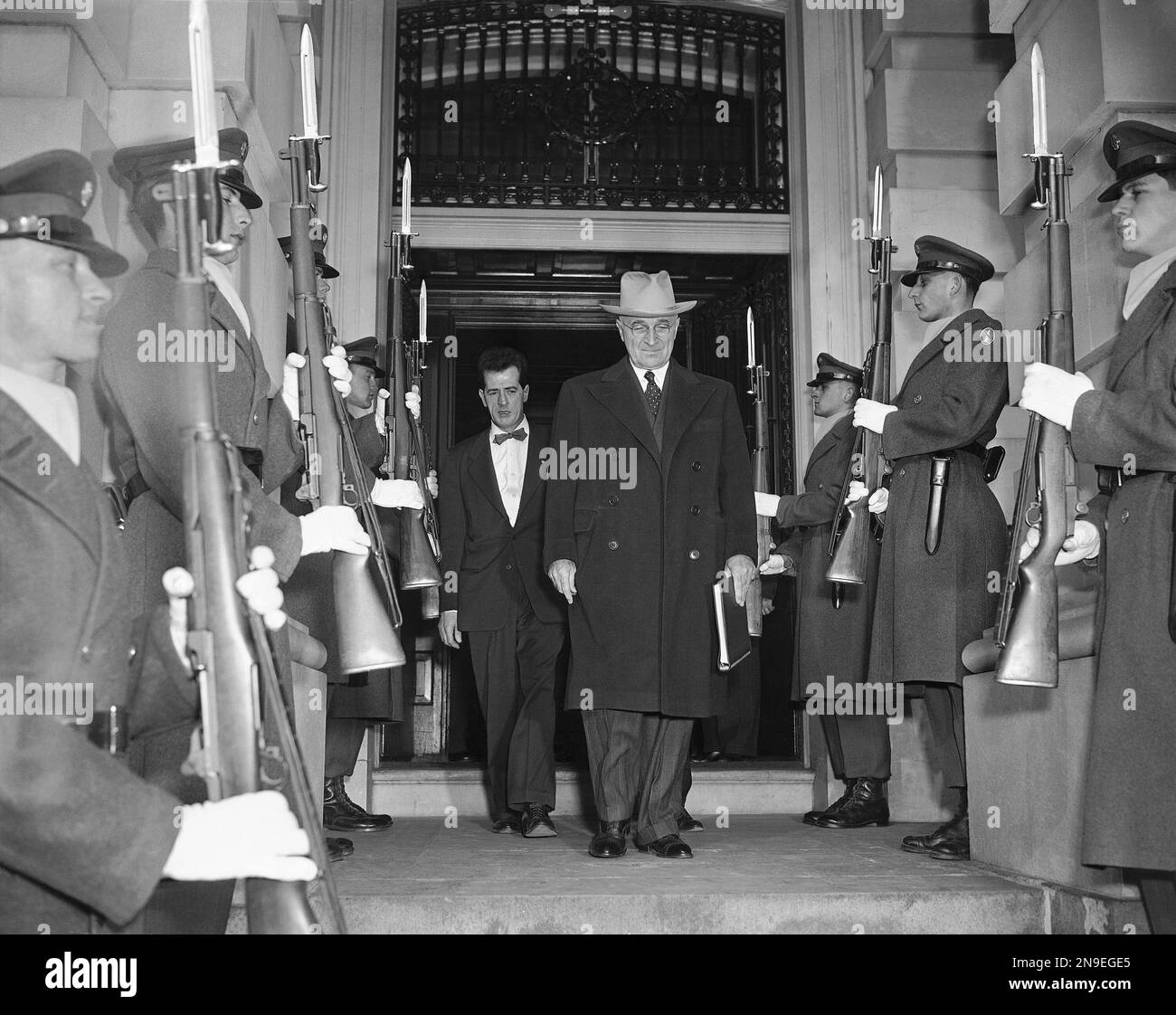Soldiers with fixed stand at attention as President Harry