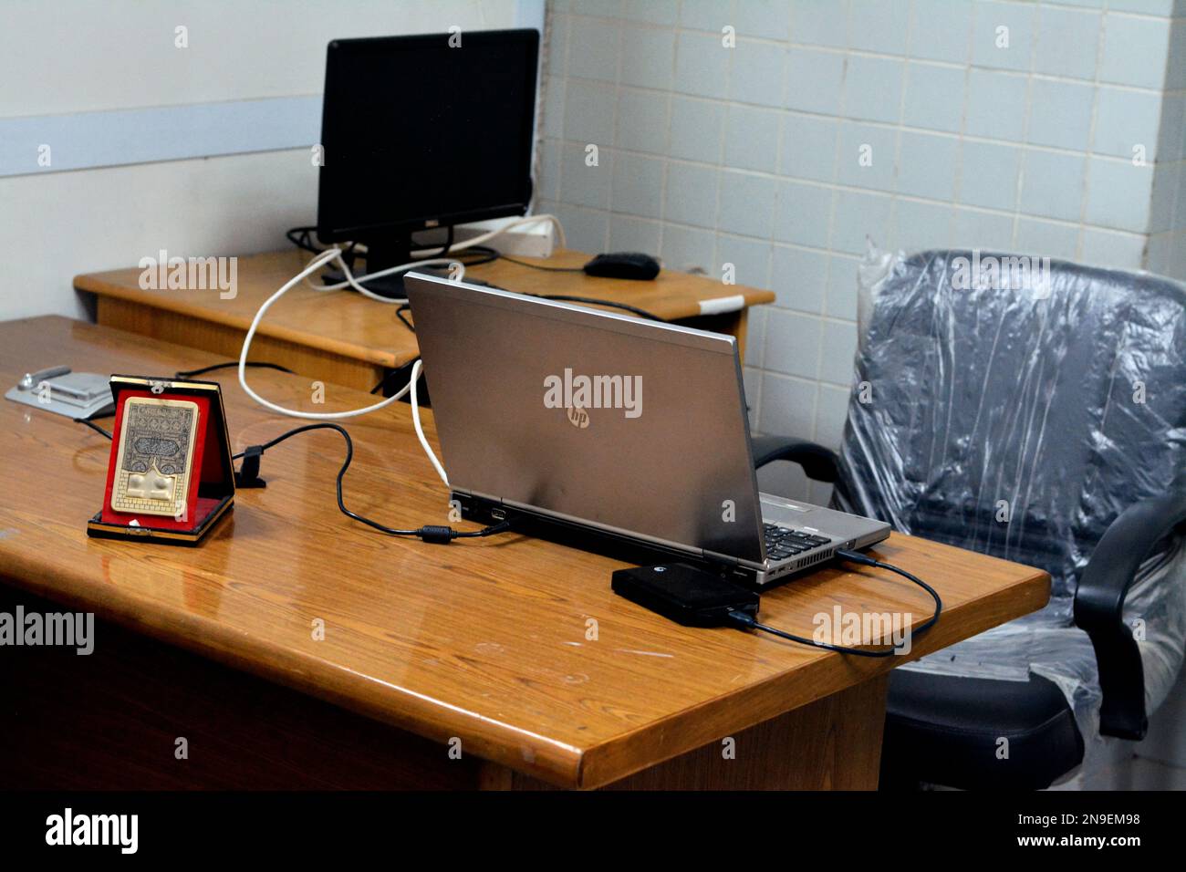 Cairo, Egypt, February 11 2023 A simple workplace with wooden desk and