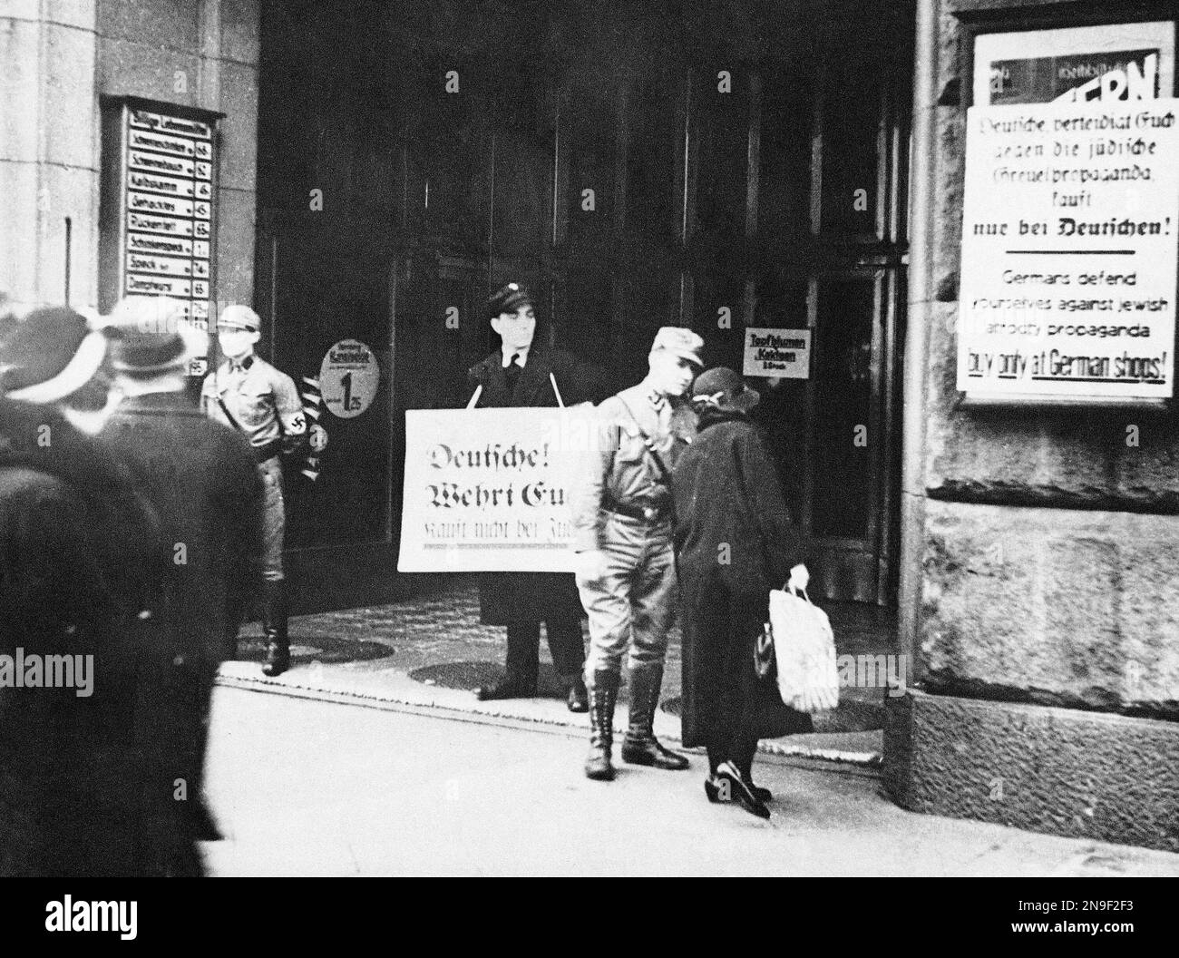Uniformed Nazi Stops A Customer To Persuade Her To Boycott A Jewish uniformed-nazi-stops-a-customer-to-persuade-her-to-boycott-a-jewish