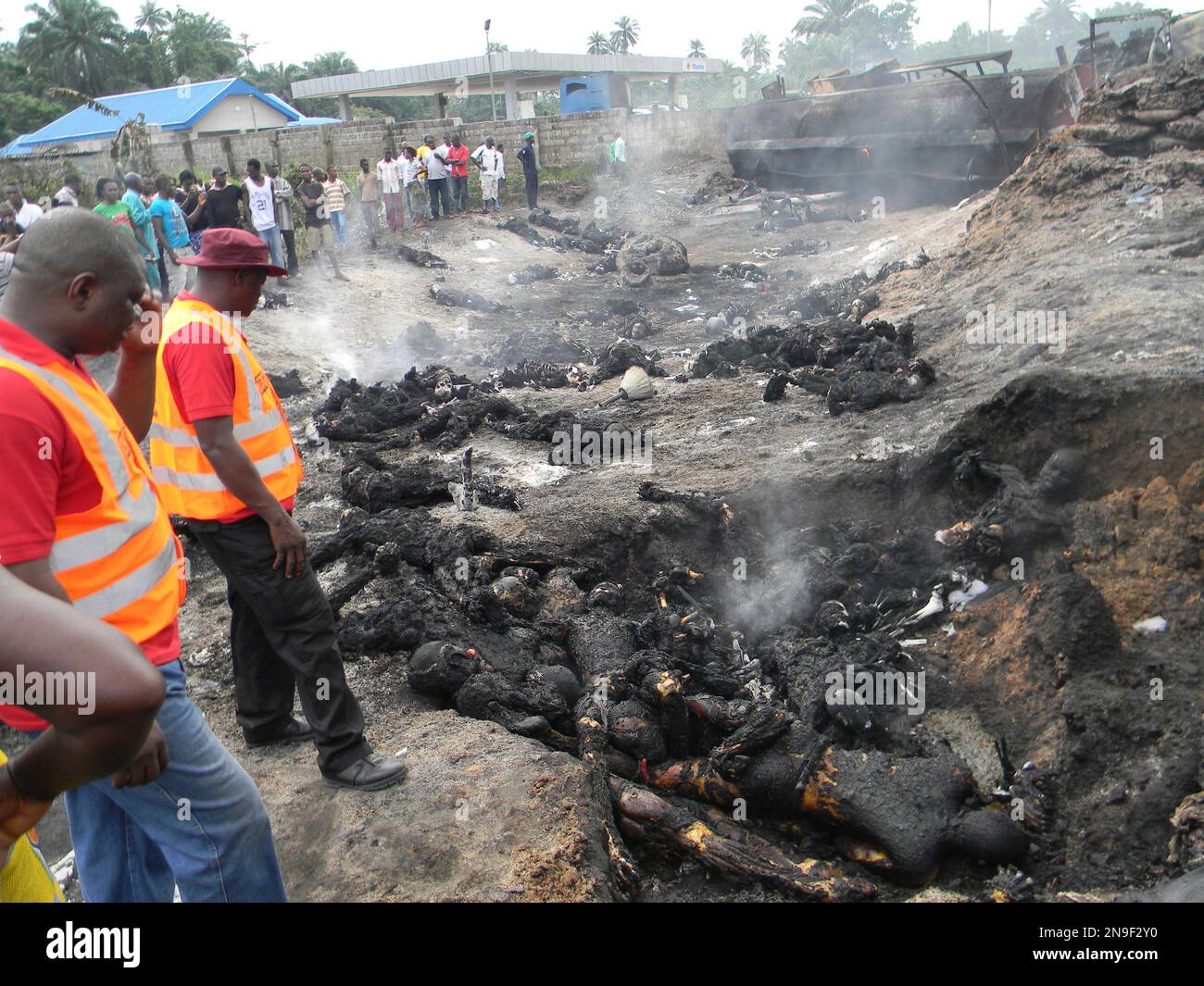 EDS NOTE GRAPHIC CONTENT People look at charred bodies following fuel