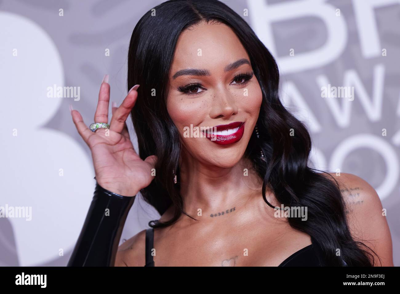 Munroe Bergdorf poses for photographers upon arrival at the Brit Awards