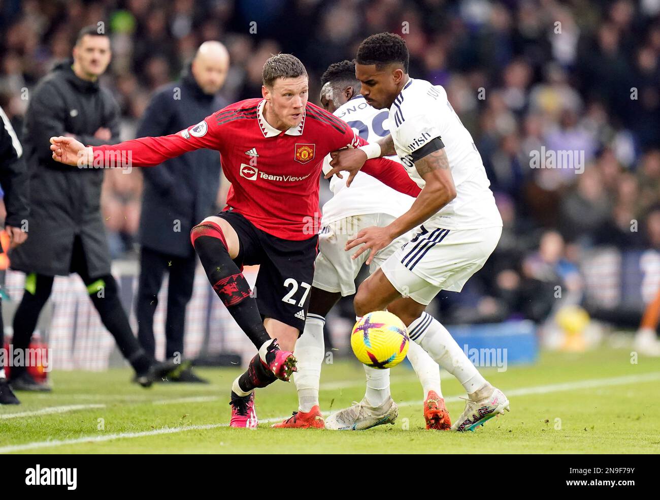 Manchester United's Wout Weghorst and Leeds United's Junior Firpo