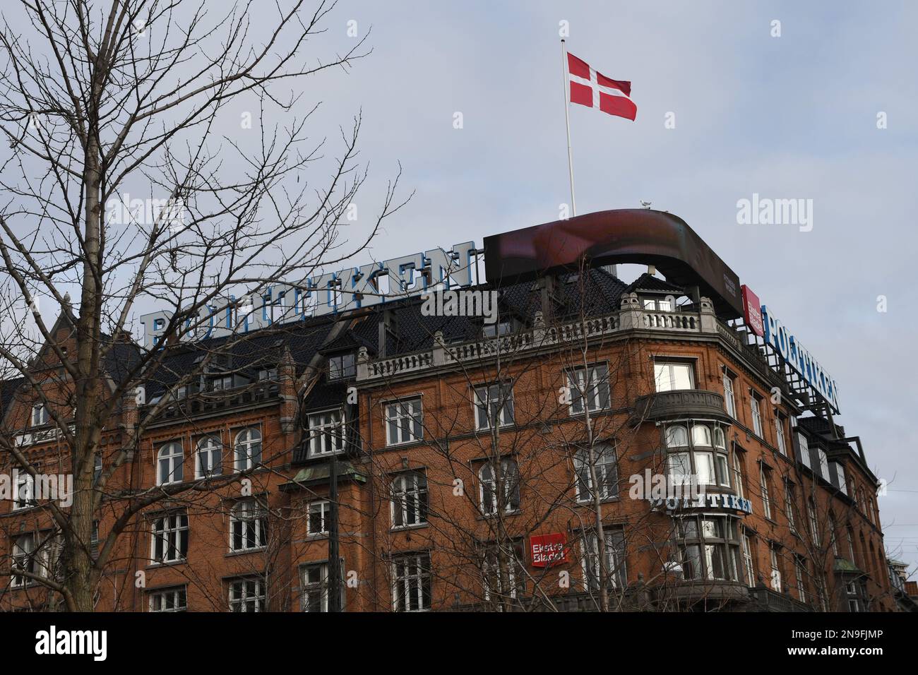 Copenhagen/Denmark/12 February 2023/ Danish media Politken hus  danish media house fly dnnebrog  danish flag on memdia house in capital Copenhagen Denmark.  (Photo. Francis Joseph Dean/Dean Pictures) Stock Photo