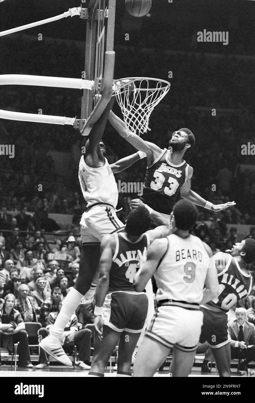 New York Knick's Bob McAdoo reaches out and blocks a shot by Philadelphia  76ers' Julius Erving