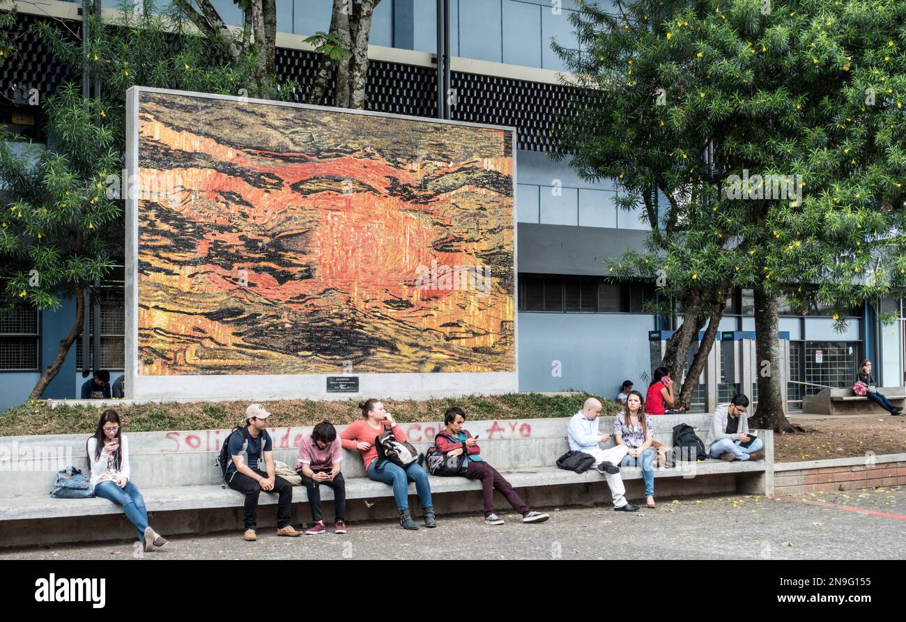 Students sitting beneath a large mosaic art work at the University of Costa Rica in San Pedro. Stock Photo