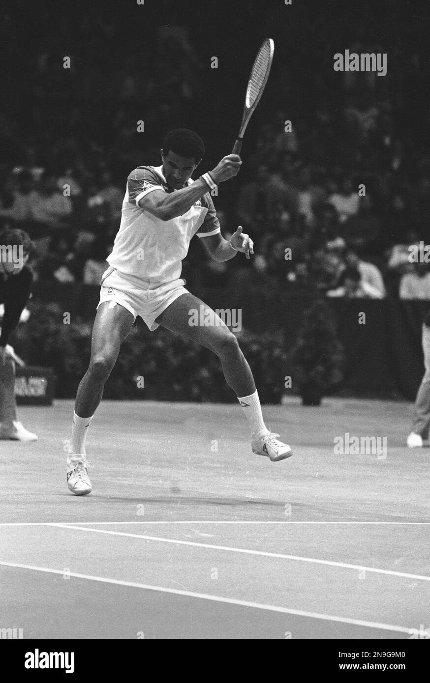 Yannick Noah of France stretches to return a shot to Ivan Lendl of