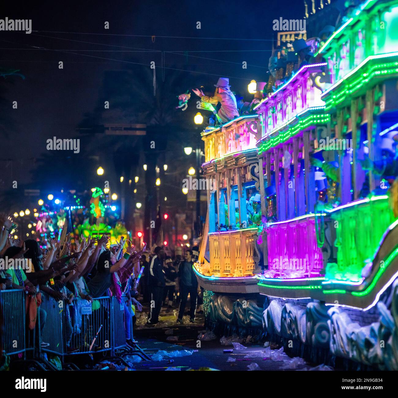 Excited parade spectators attempting to get beads and swag tossed from a float from Krewe Endymion during Mardi Gras in New Orleans, 2019 Stock Photo