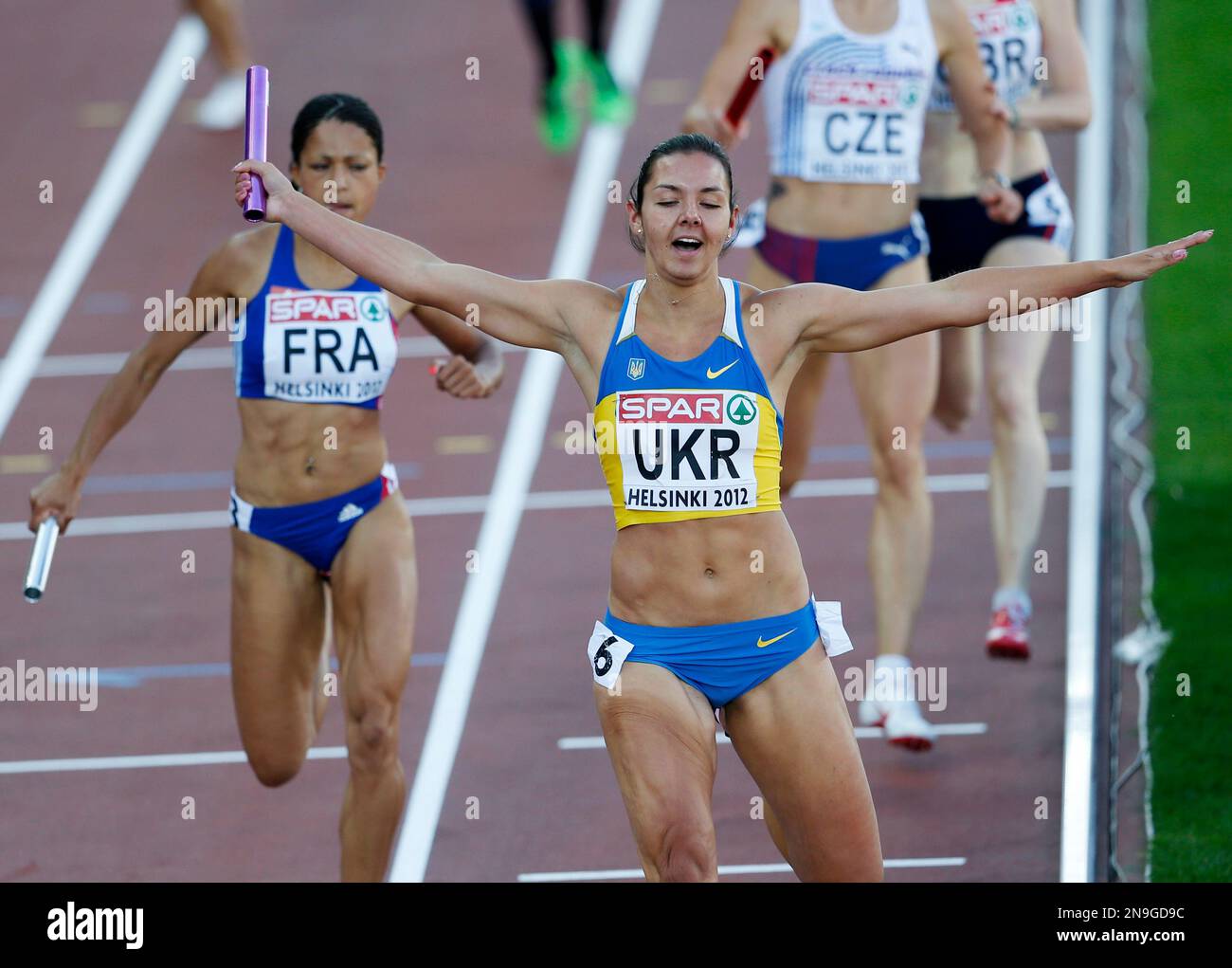 Ukraine's Yuilya Olishevska crosses the finish line to win with her