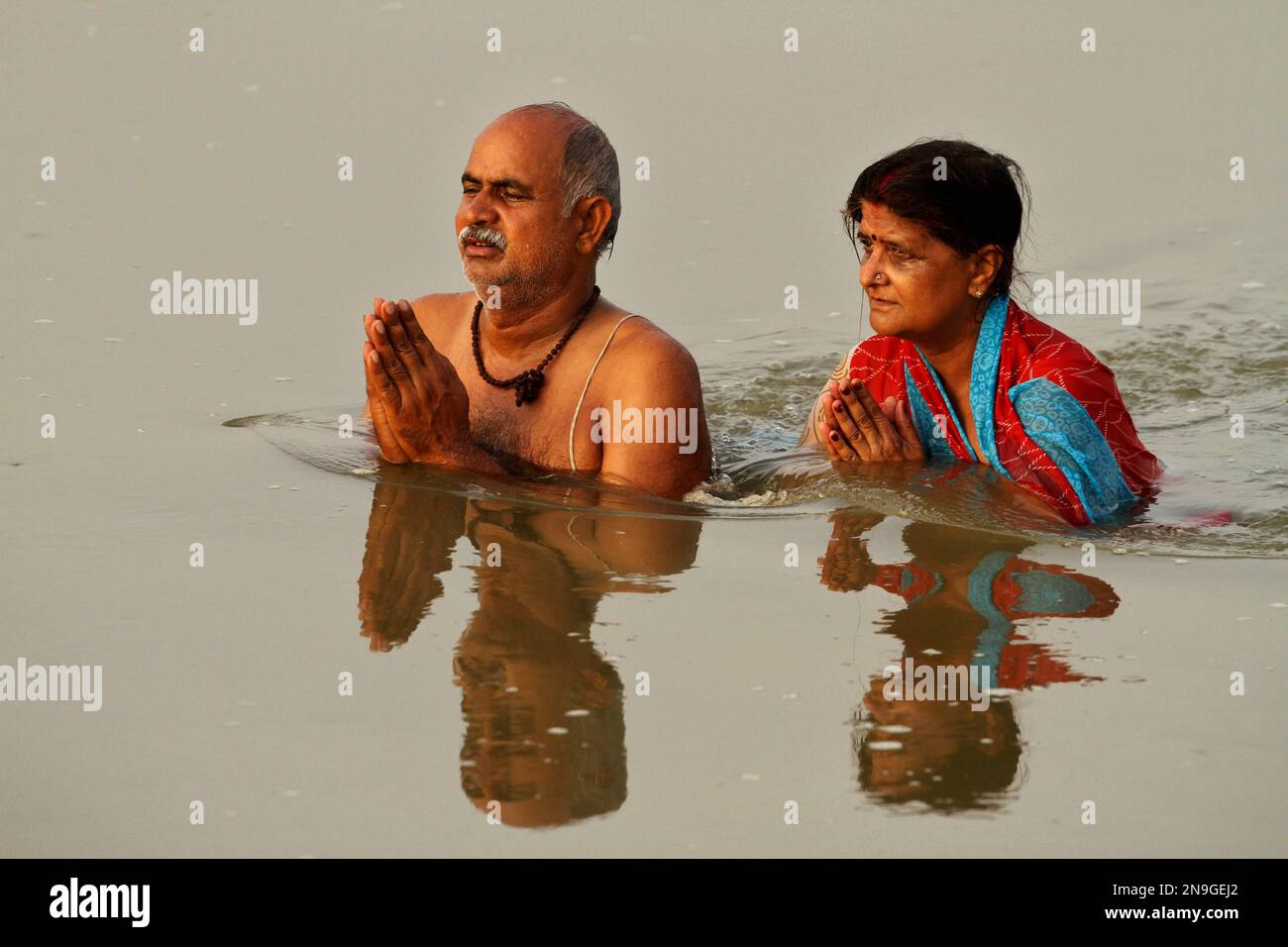 A Hindu Couple Offers Prayers To The Sun God As They Take A Holy Dip In 