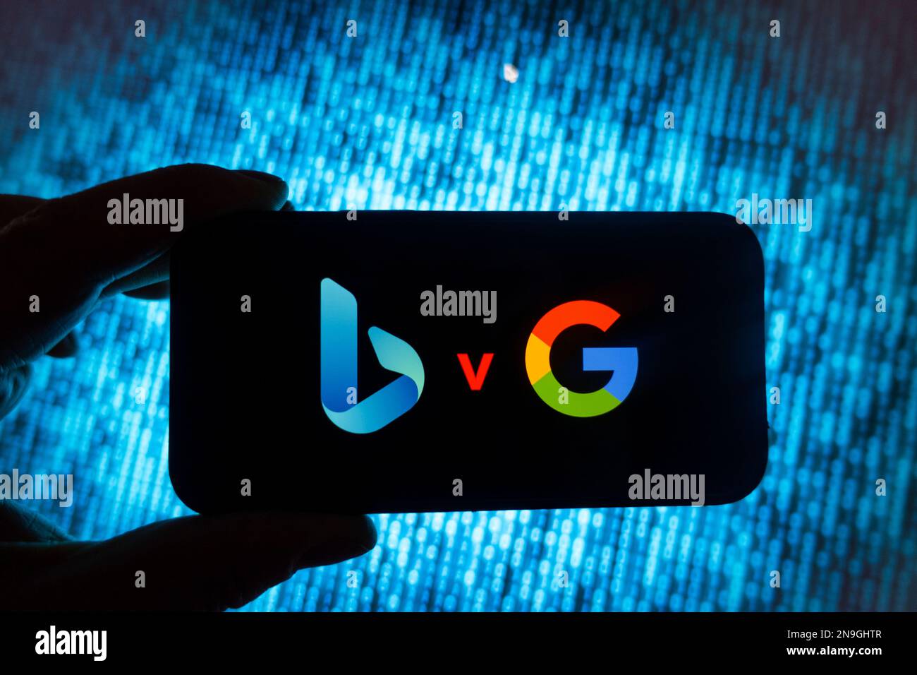 Digital composite image showing Microsoft Bing search engine powered by ChatGPT and Google search on a mobile phone. Stock Photo